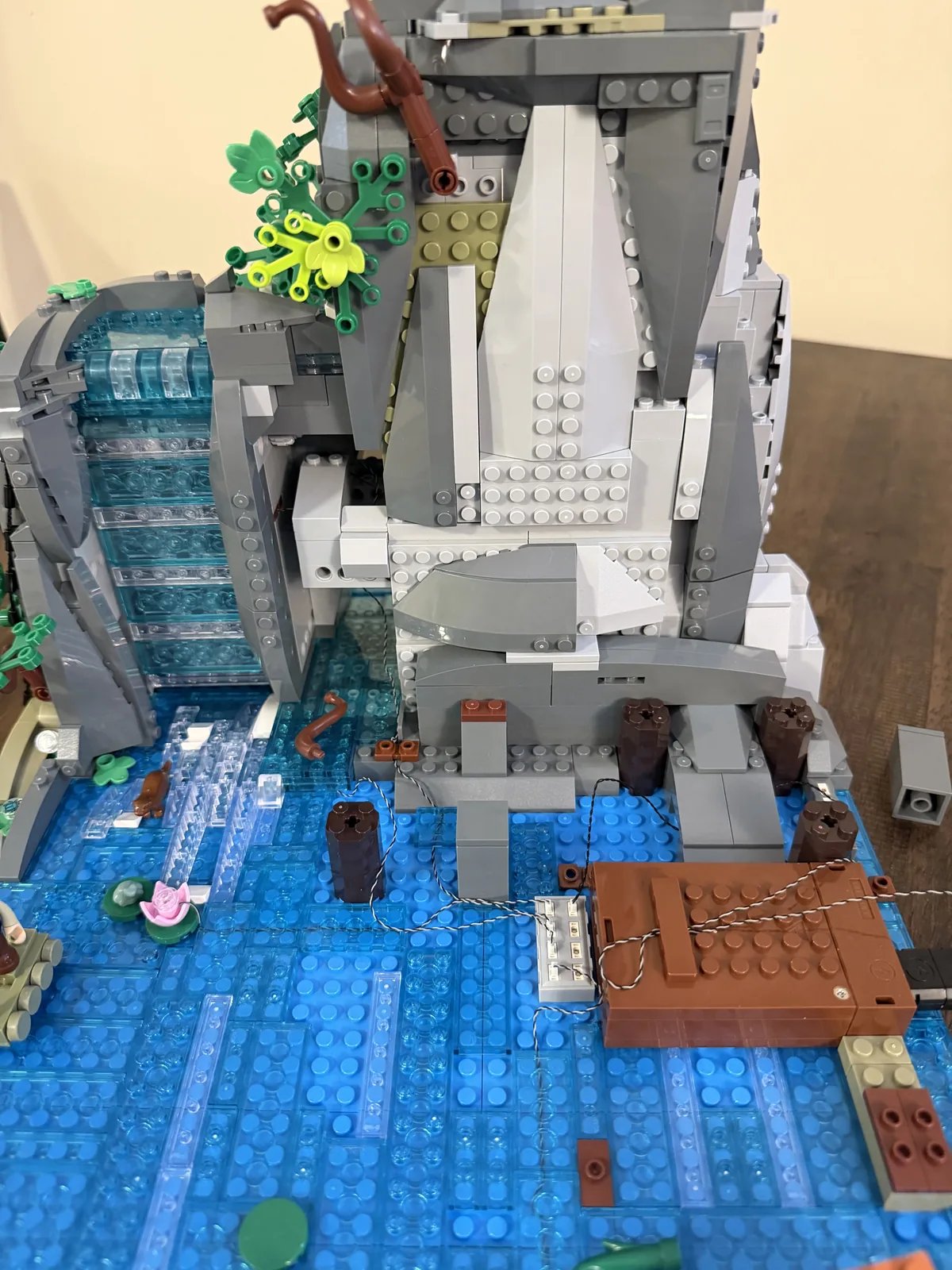 Lumibricks 10010 Waterfall Cabin — mountain and waterfall with cabin removed, battery box and wiring exposed