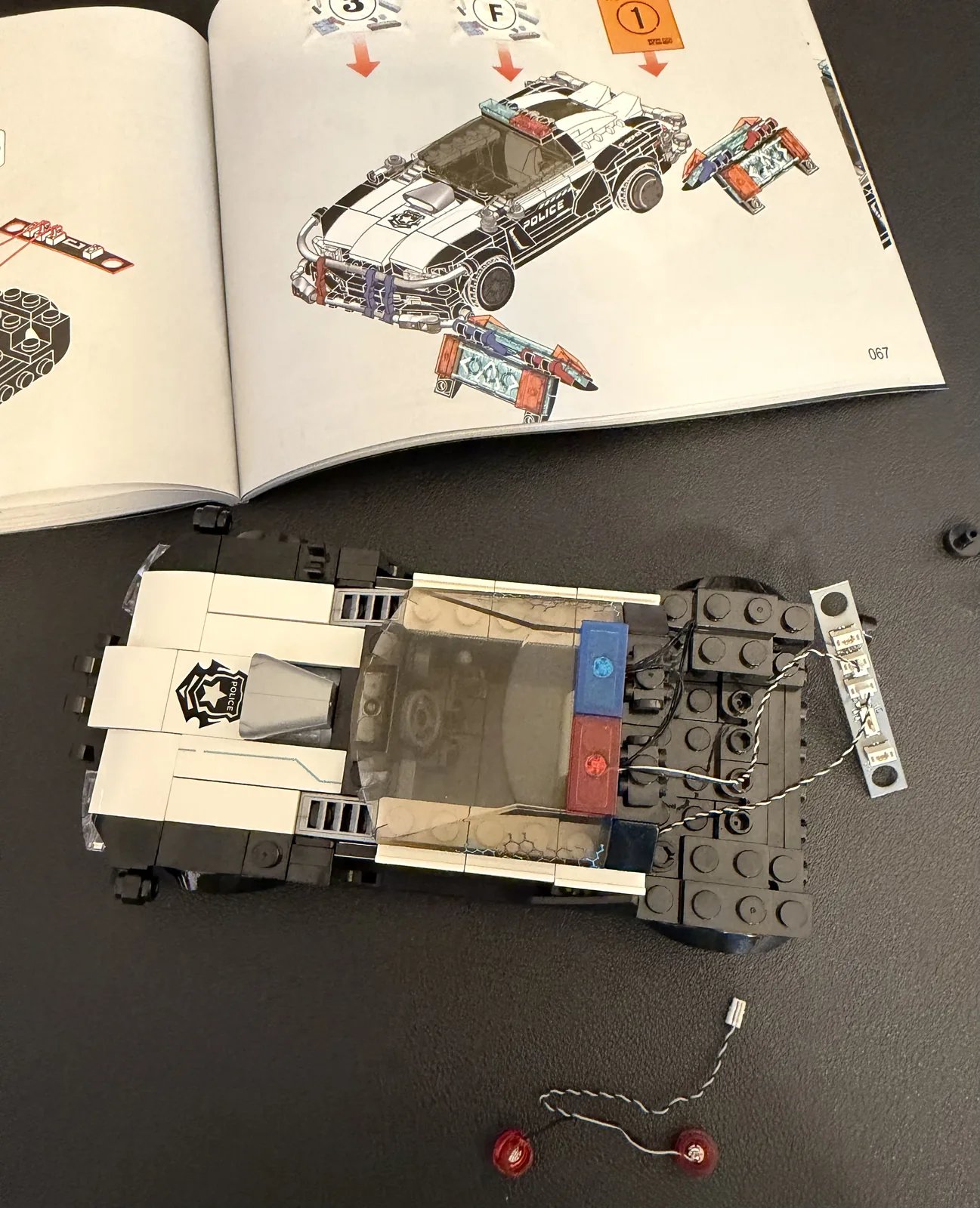 Lumibricks F9043 Police Patrol Car — early chassis build with LED wiring