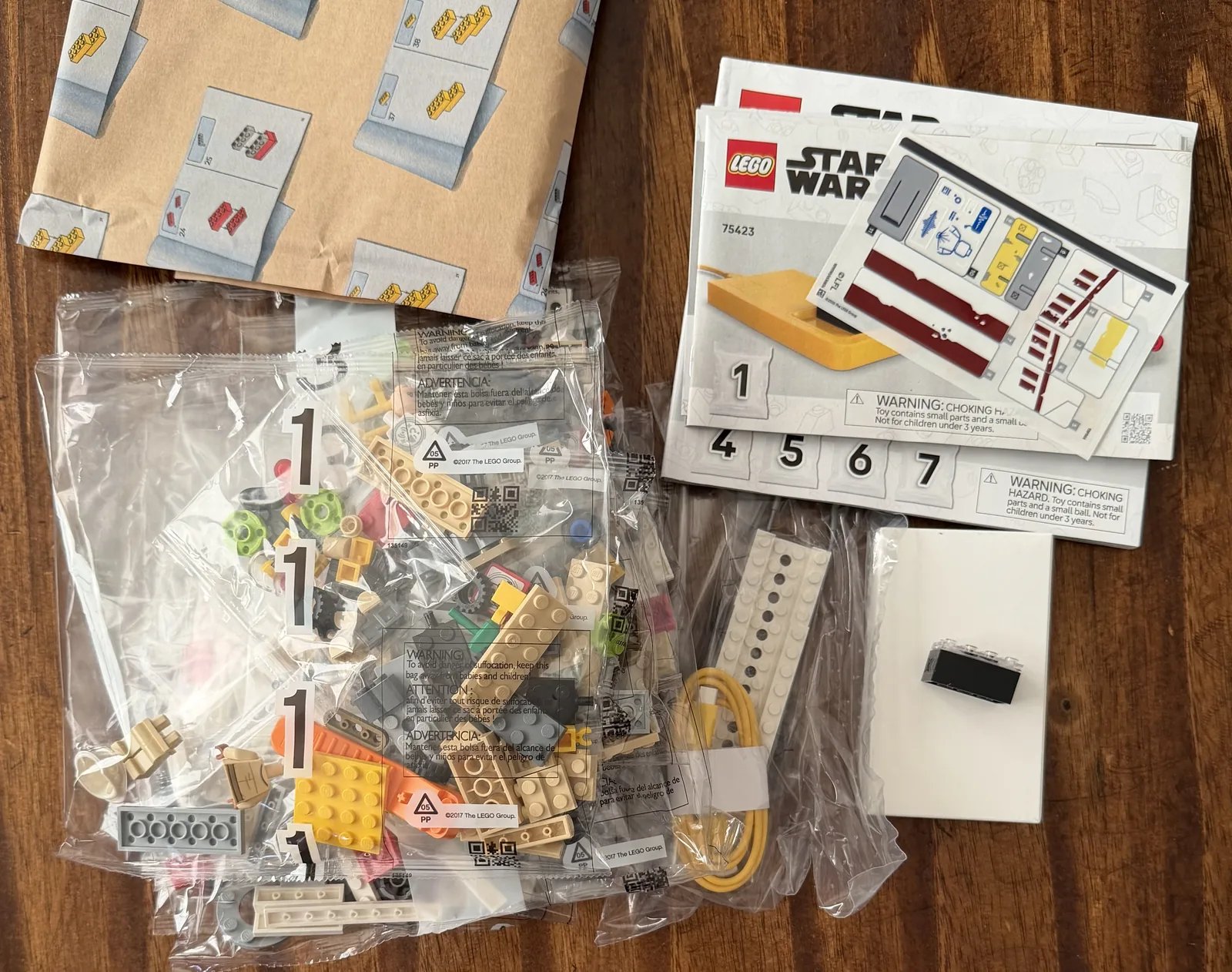 LEGO 75423 X-Wing box contents: numbered bags, instruction booklet, and the Smart Brick