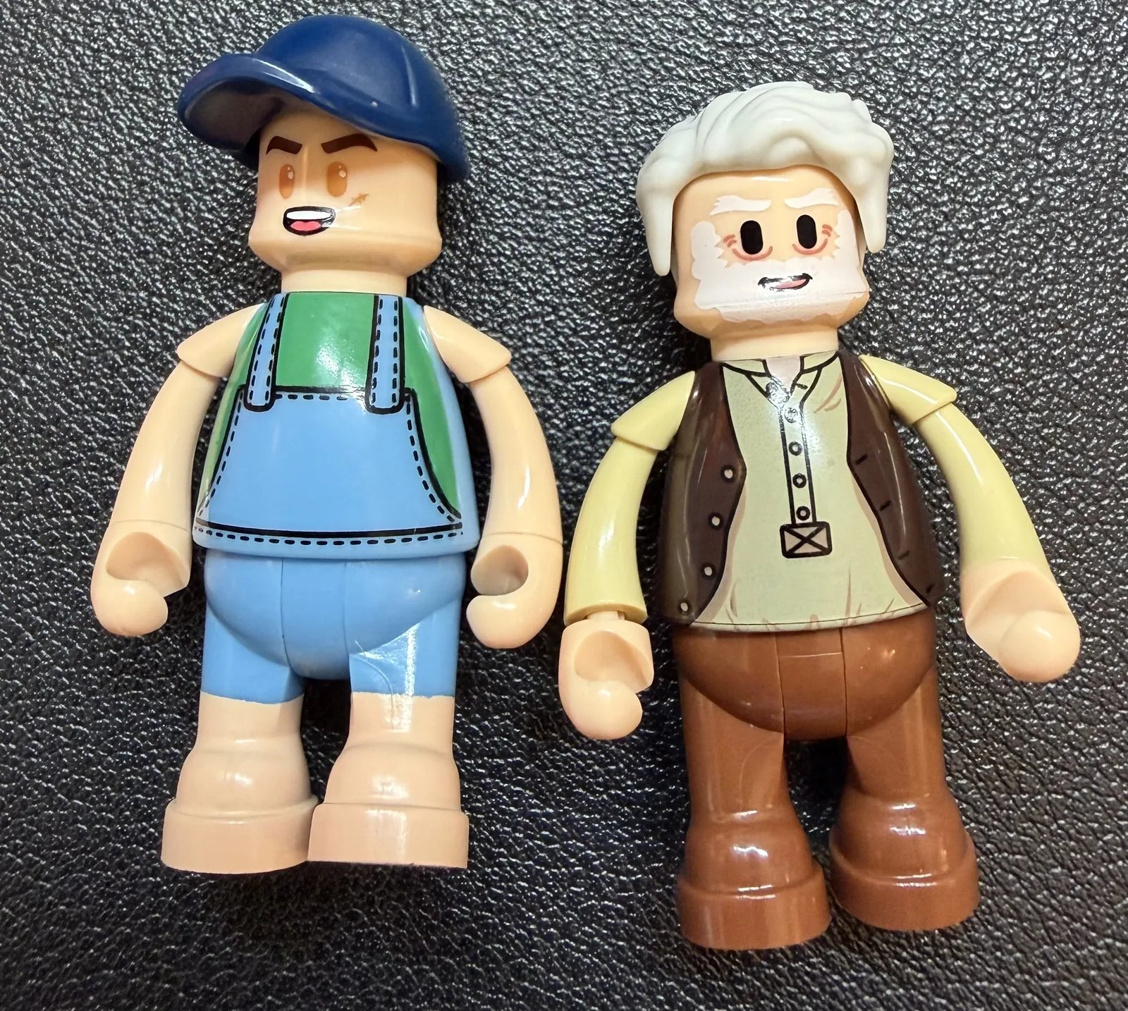Lumibricks 10010 Waterfall Cabin — two minifigures side by side on a dark surface